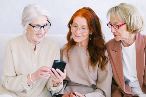 three older ladies using their mobile phone